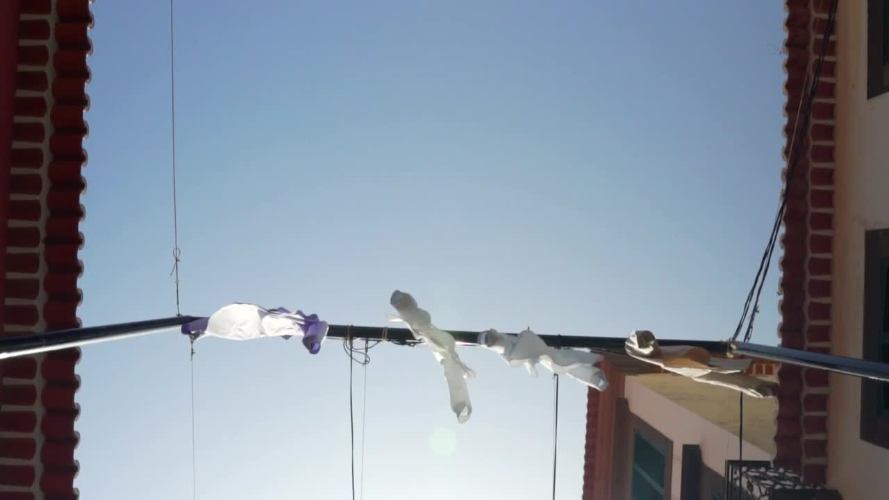 Free Video Stock tourist town street with shirts hung as decorations Live Wallpaper