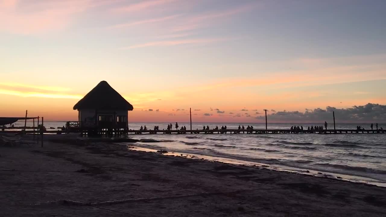 Free Video Stock tourists watching the sunset on a pier Live Wallpaper