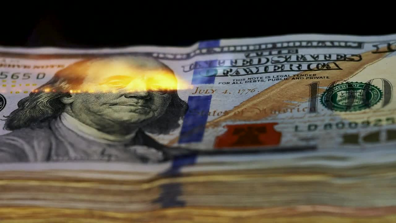 Free Video Stock tower of  dollars being burned with a flame Live Wallpaper
