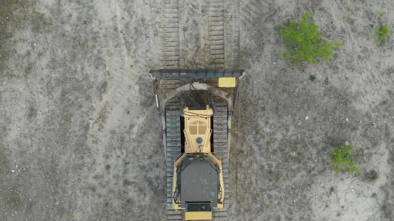 Free Video Stock tracked bulldozer driving on a sandy road Live Wallpaper