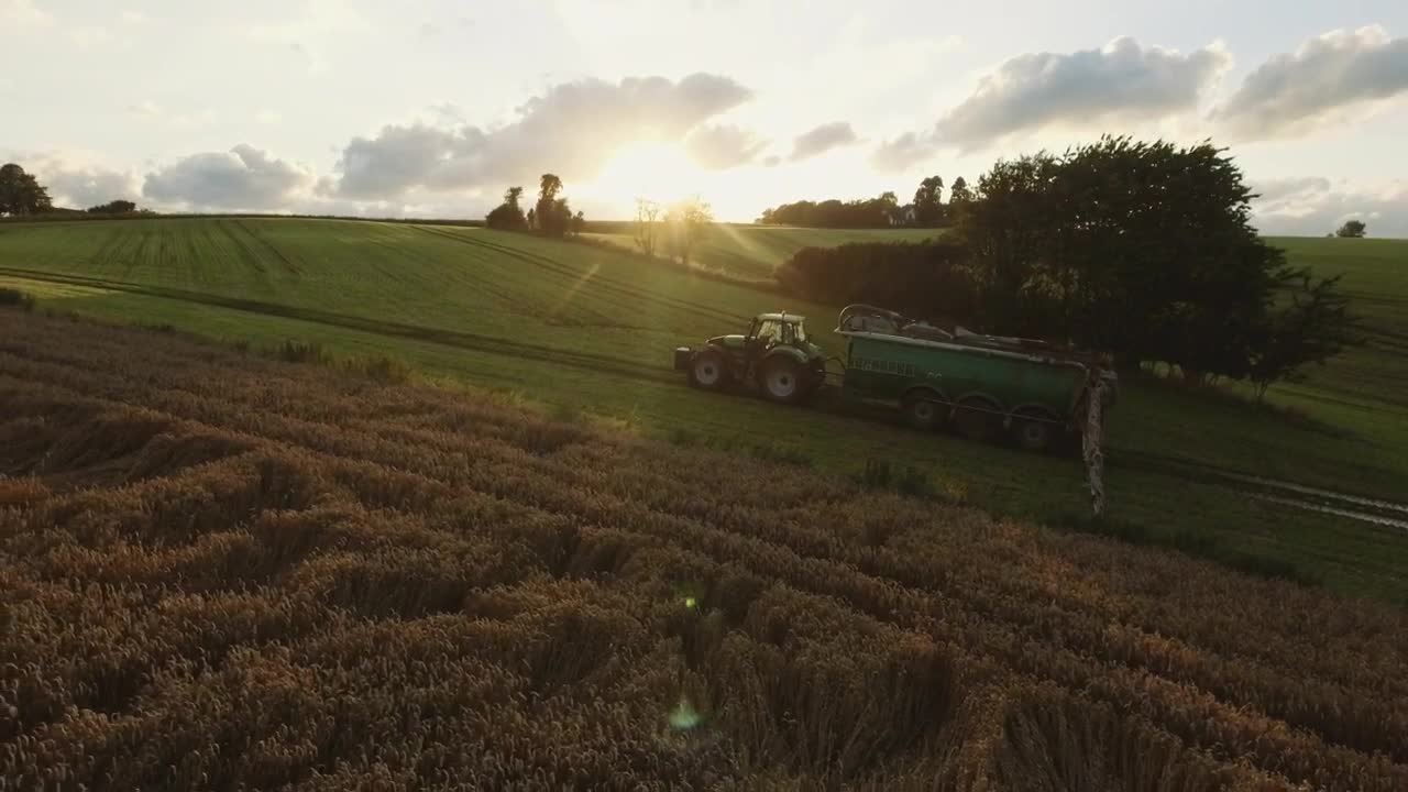 Free Video Stock tractor driving over green fields Live Wallpaper