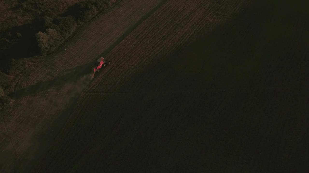 Free Video Stock tractor moving across a field Live Wallpaper