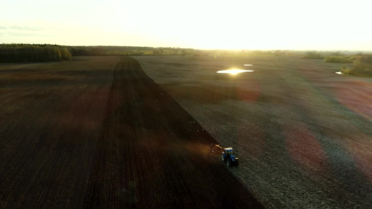 Free Video Stock tractor working in the field with sunbeams Live Wallpaper