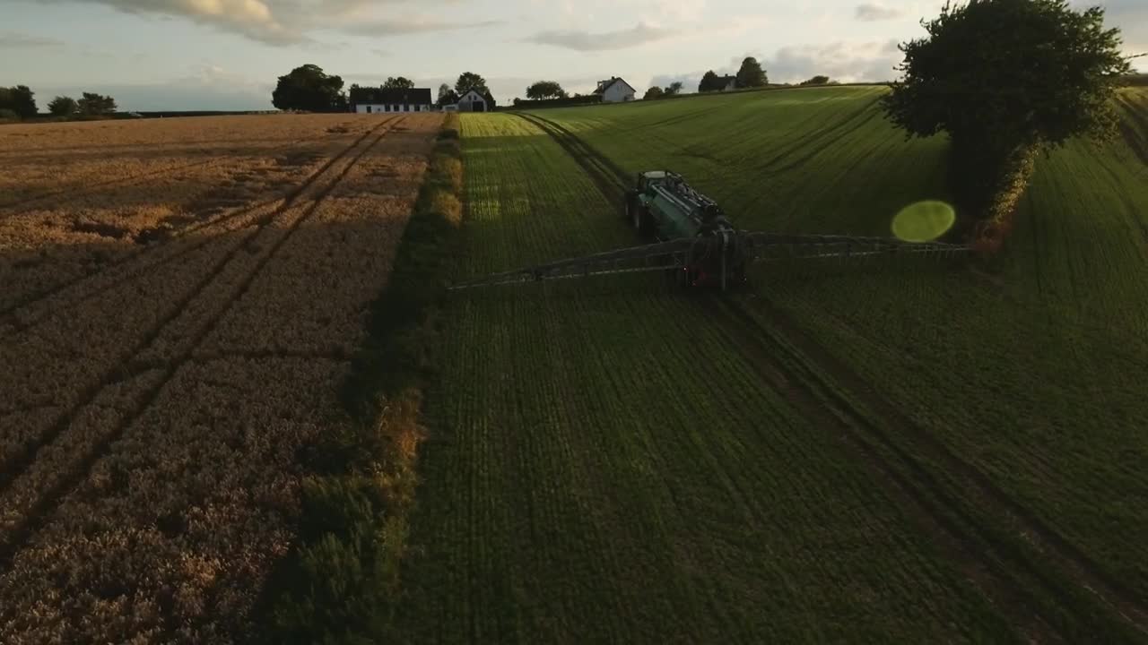 Free Video Stock tractor working near a farmhouse Live Wallpaper