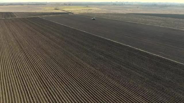 Free Video Stock tractor working on a large agricultural field Live Wallpaper
