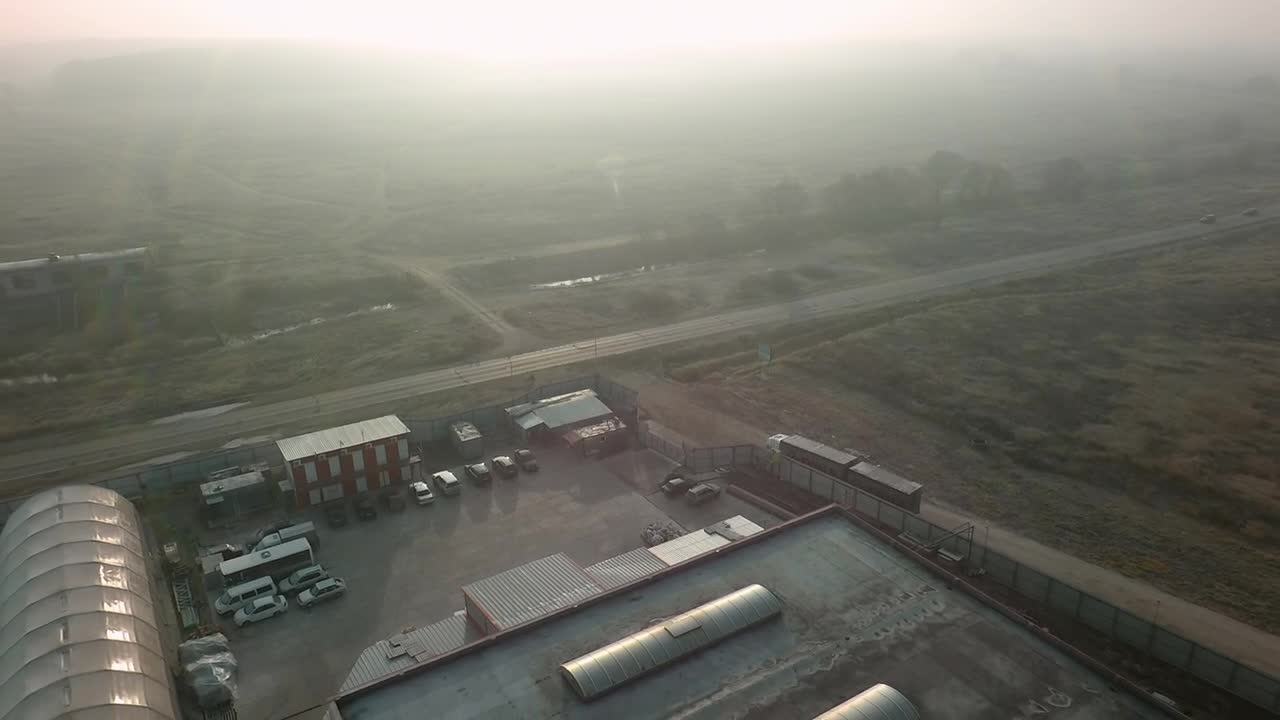 Free Video Stock traffic driving by a warehouse Live Wallpaper