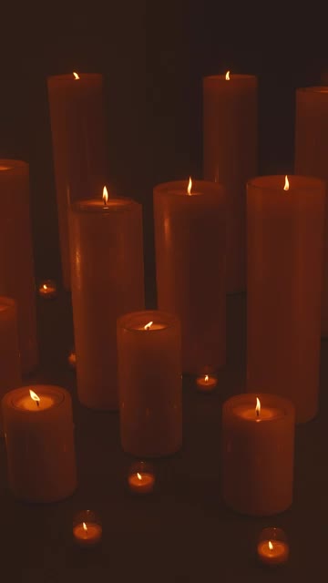 Free Stock Video Very Large And Very Small Candles Lit In The Dark Smalllive Wallpaper