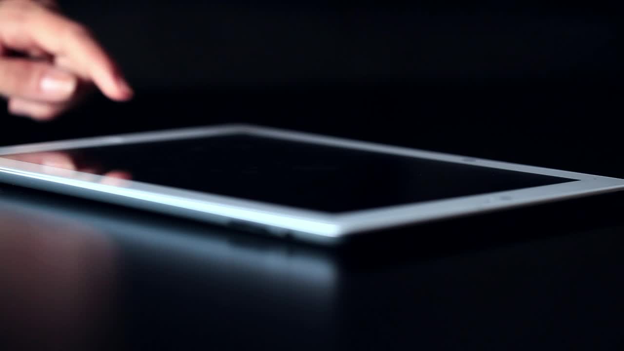 Free Stock Video Using A Tablet On A Dark Table Live Wallpaper