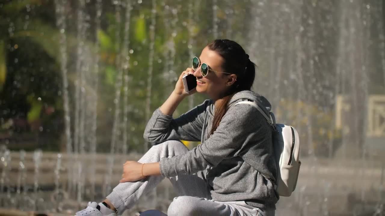 Free Stock Video Urban Woman Taking A Call Next To A Fountain Live Wallpaper