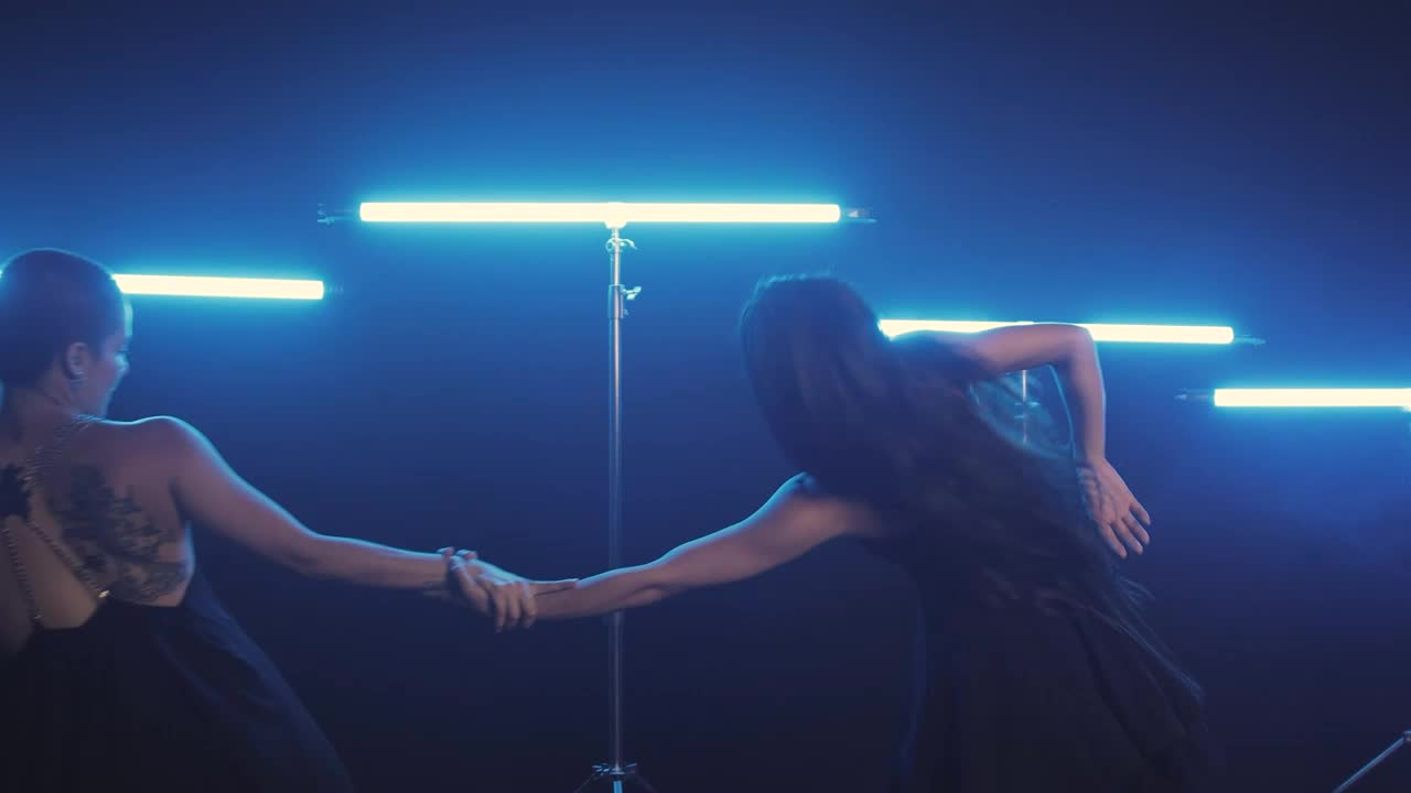 Free Stock Video Two Women Dancing Illuminated With Blue Light Bars Live Wallpaper