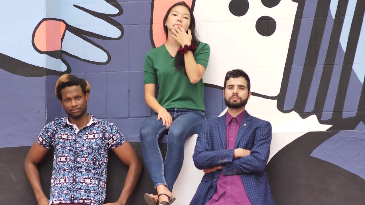 Free Stock Video Two Men And A Woman Looking Serious In Front Of Live Wallpaper