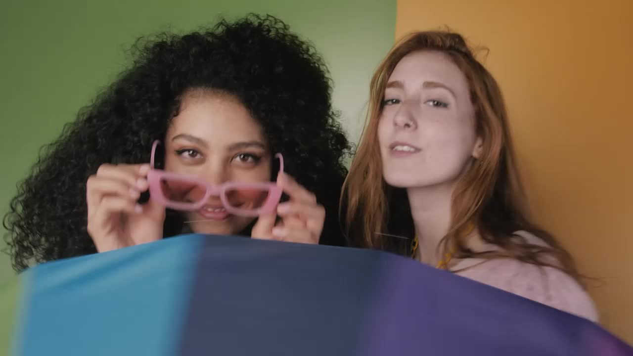 Free Stock Video Two Girls Having Fun With A Colorful Umbrella Live Wallpaper