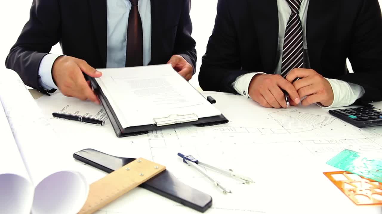 Free Stock Video Two Businessmen In Suits Reviewing Some Documents Live Wallpaper