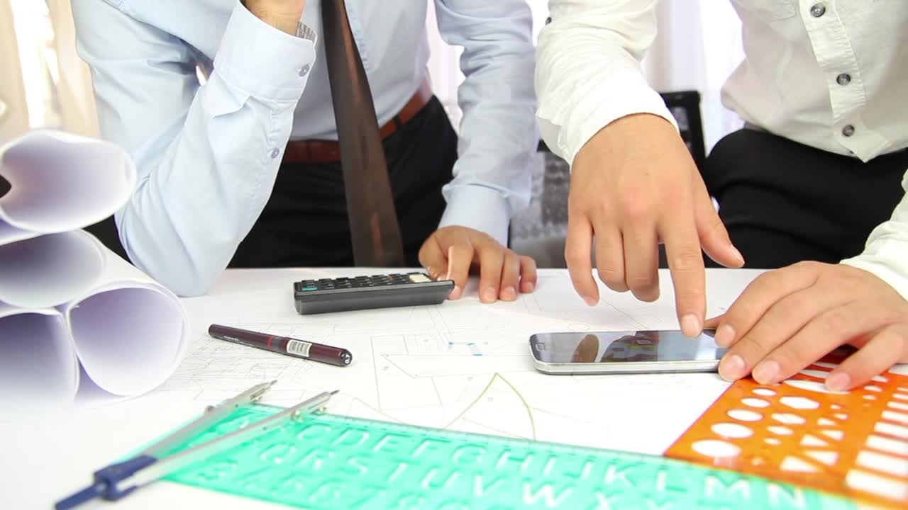 Free Stock Video Two Architects Discussing A Project On A Desk Live Wallpaper