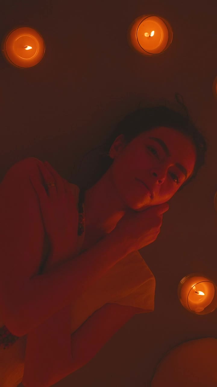 Free Stock Video Young Woman Lying On The Floor Surrounded By Candles Live Wallpaper