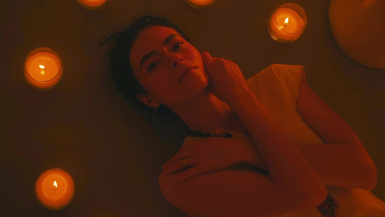 Free Stock Video Young Woman Lying On The Floor Among Many Candles Live Wallpaper