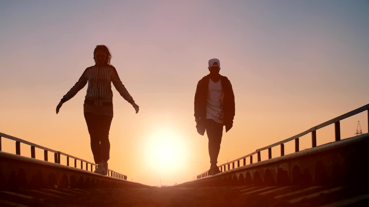 Free Stock Video Young Urban Couple Walking On The Train Tracks Live Wallpaper