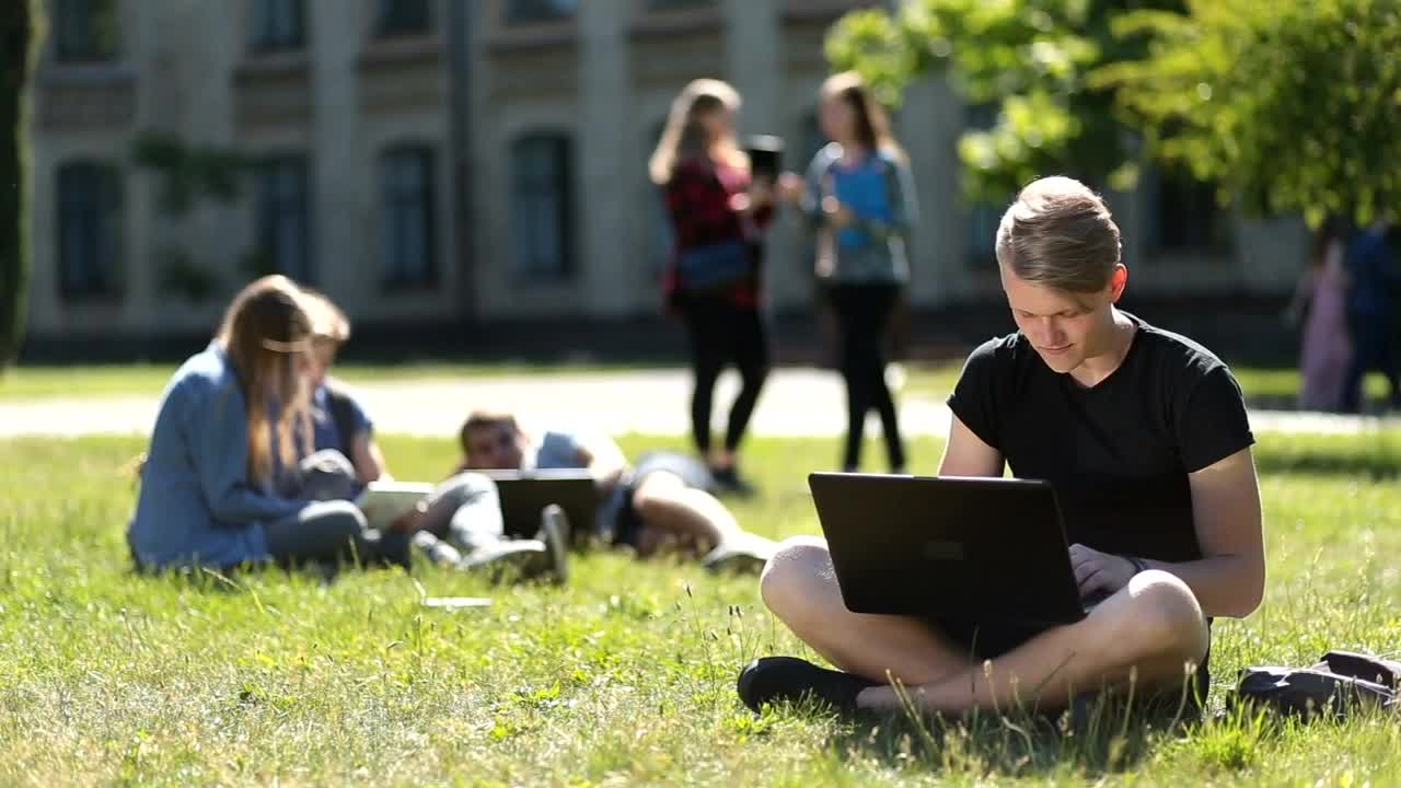 Free Stock Video Young Students Hanging Out On A Campus Meadow Live Wallpaper