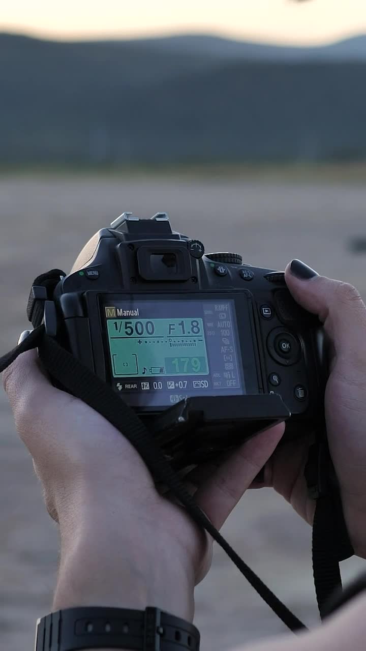 Free Stock Video Young Photographer Setting Up His Camera Outdoors Live Wallpaper