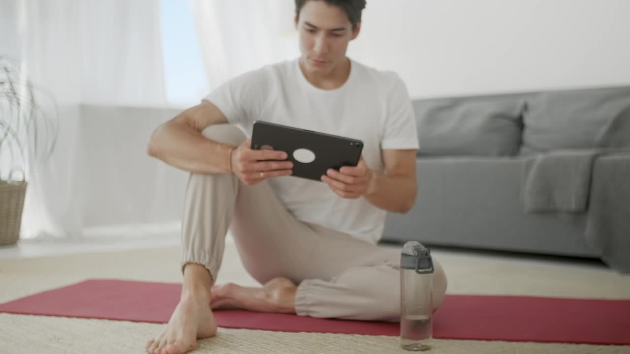 Free Stock Video Young Man Watching Yoga Videos For Practice Live Wallpaper