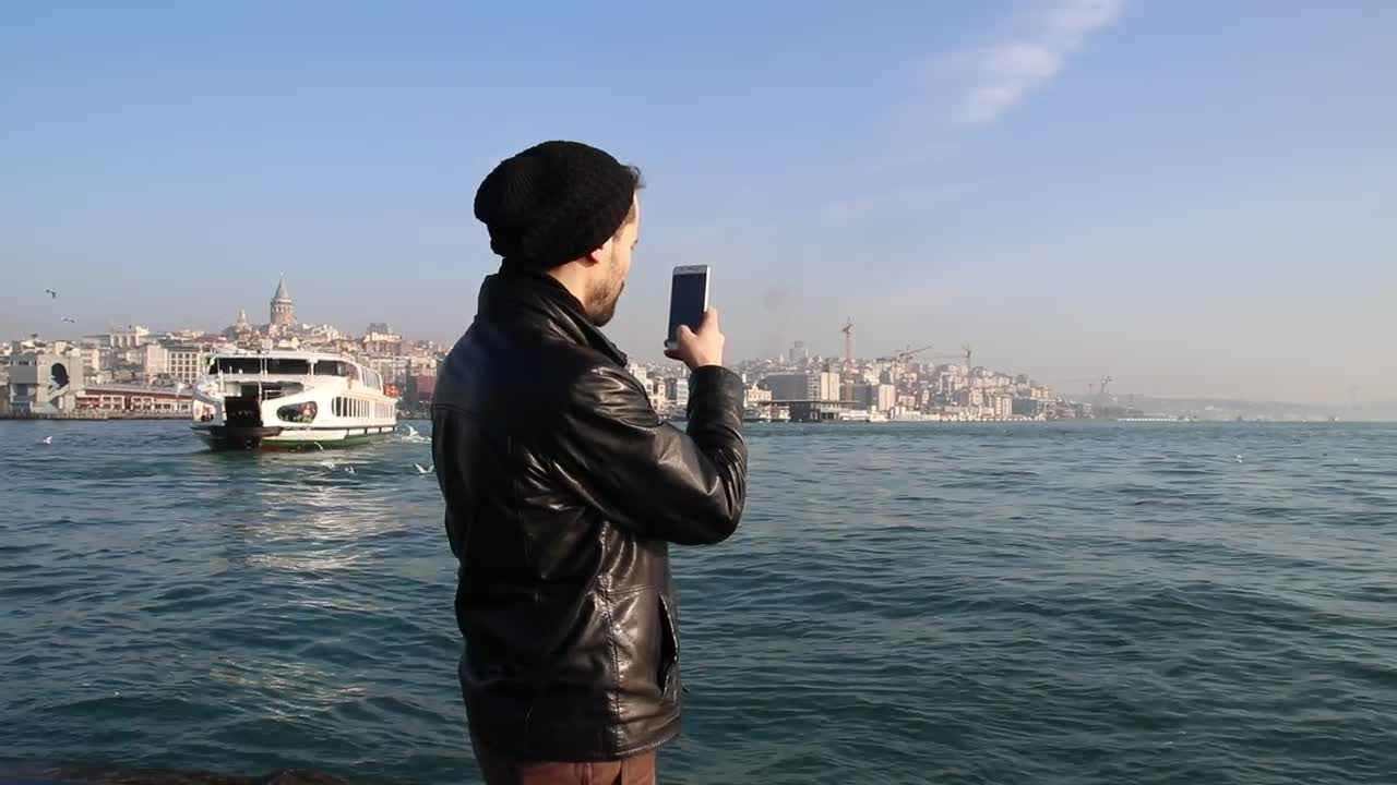 Free Stock Video Young Man Taking Photos On A Sunny Shore Live Wallpaper