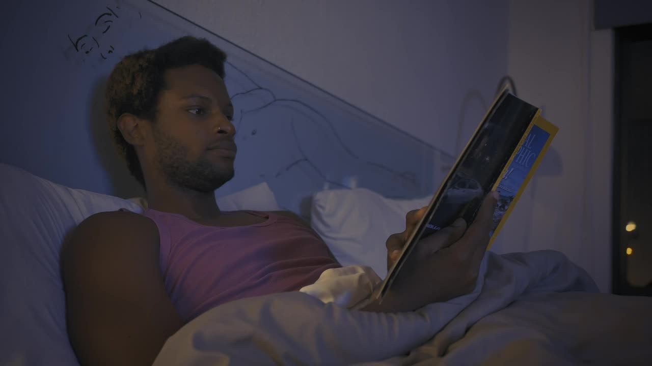 Free Stock Video Young Man Reading A Book Before Going To Sleep Live Wallpaper