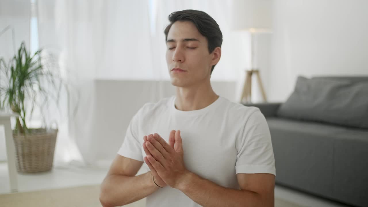 Free Stock Video Young Man Meditating In The Living Room Live Wallpaper