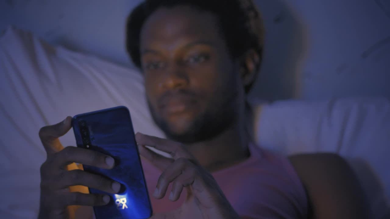Free Stock Video Young Man Lying On His Bed Checking His Smartphone Live Wallpaper