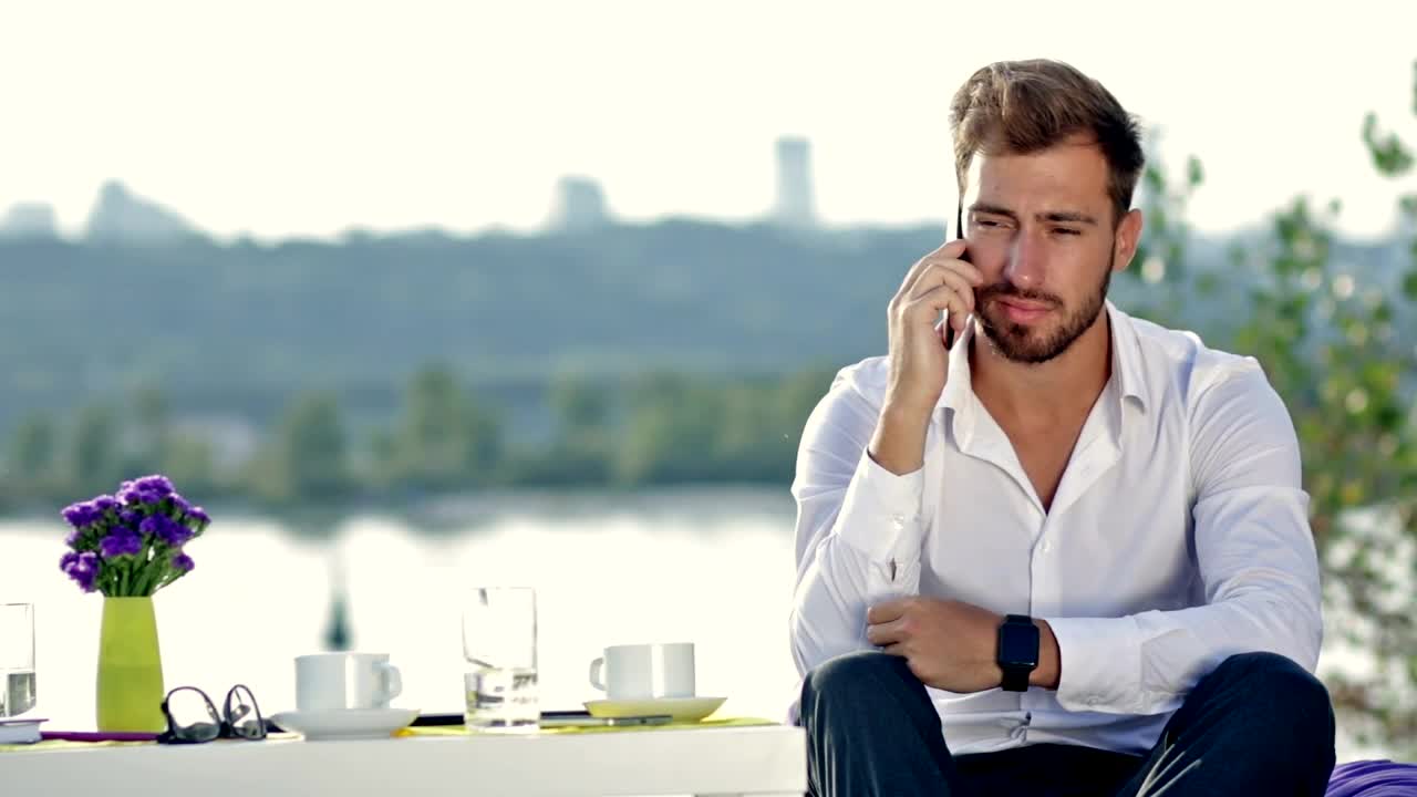 Free Stock Video Young Man At A Table Outdoors On A Call Live Wallpaper