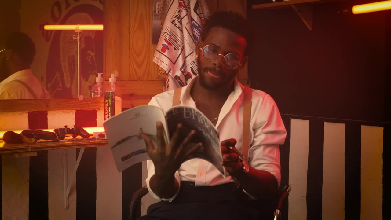 Free Stock Video Young Barber Hanging Out Sitting In His Barbershop Live Wallpaper