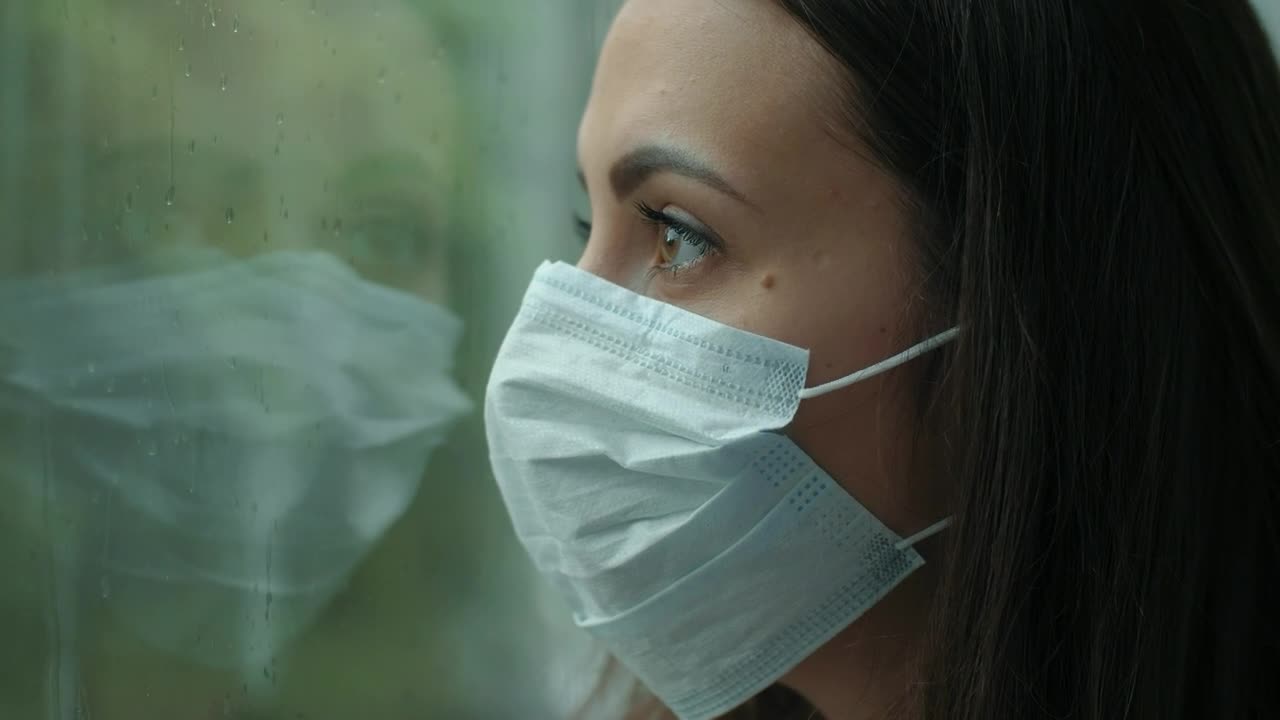 Free Stock Video Woman With Mask Looking At Rain Through Window Live Wallpaper