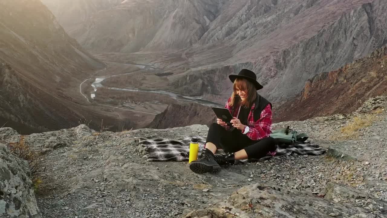 Free Stock Video Woman Using A Tablet On Top Of A Crag Live Wallpaper