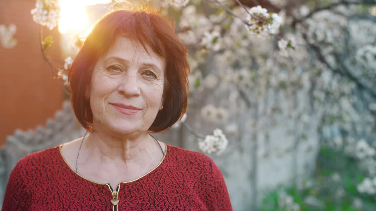 Free Stock Video Woman Smiling At Camera In Front Of A Flowering Tree Live Wallpaper