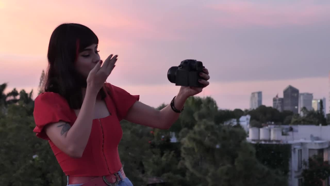 Free Stock Video Woman Shooting A Blog With City Background At The Sunset Live Wallpaper