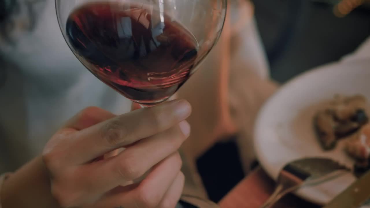 Free Stock Video Woman Shaking A Glass Of Wine Before Drinking From It Live Wallpaper