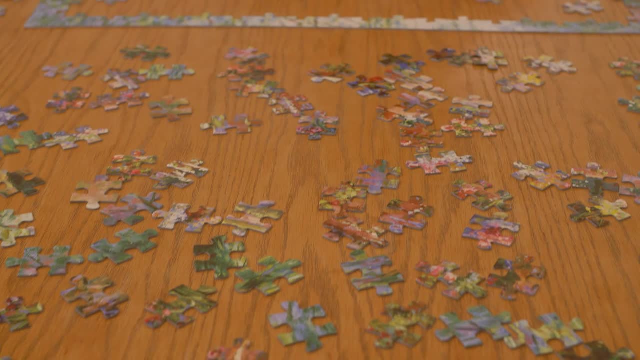 Free Stock Video Woman Putting Together A Puzzle Of Many Pieces Live Wallpaper