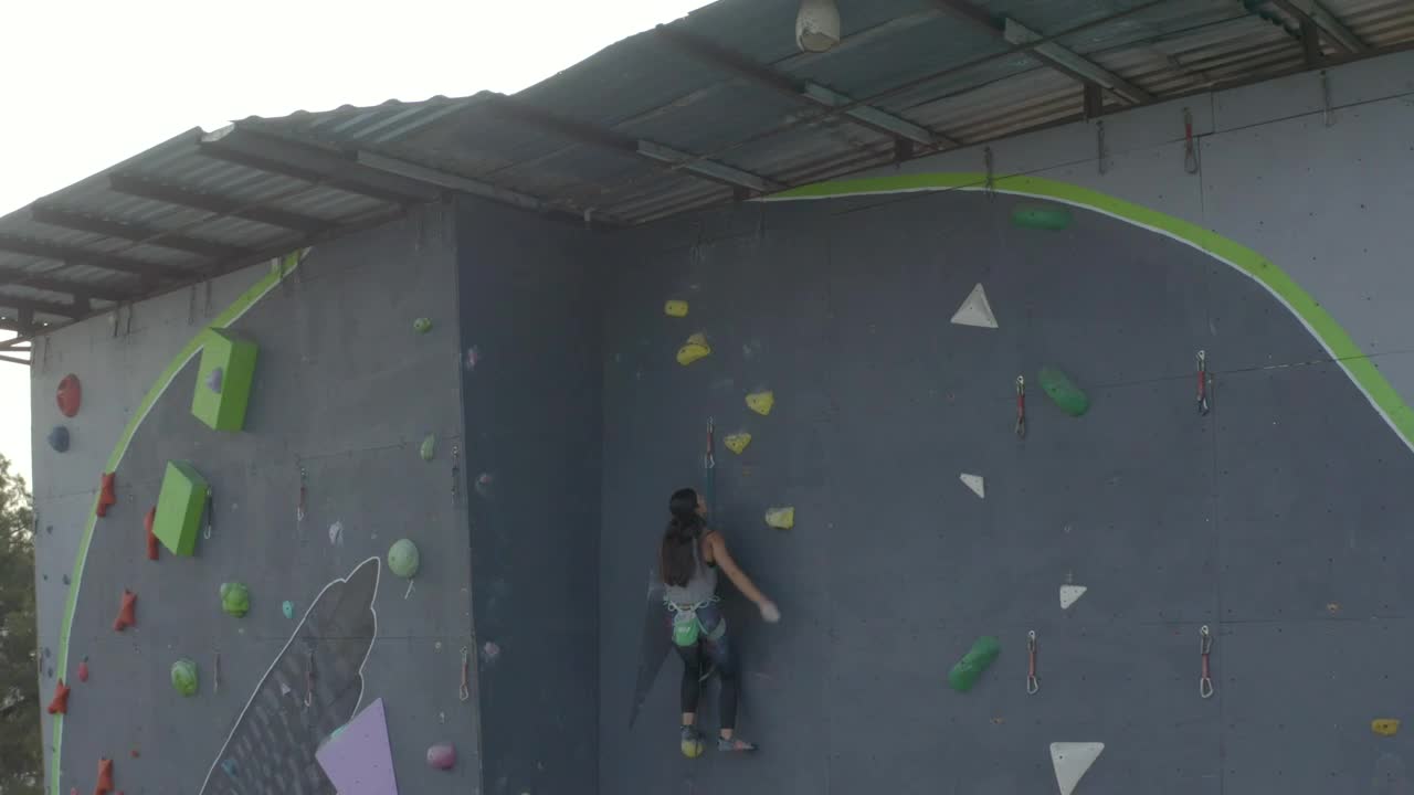 Free Stock Video Woman Reaching The Top Of A Huge Mountaineering Tower Live Wallpaper