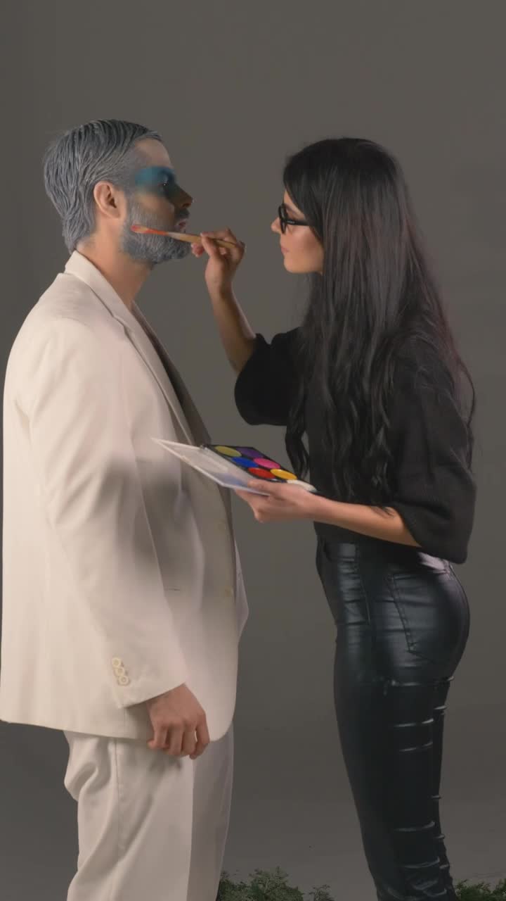 Free Stock Video Woman Putting Makeup On A Male Model Live Wallpaper
