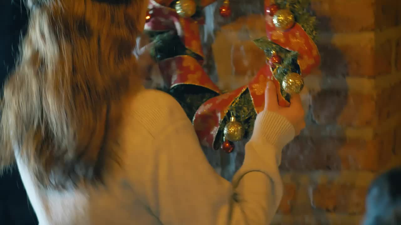 Free Stock Video Woman Placing A Christmas Wreath On A Wall In Her Live Wallpaper