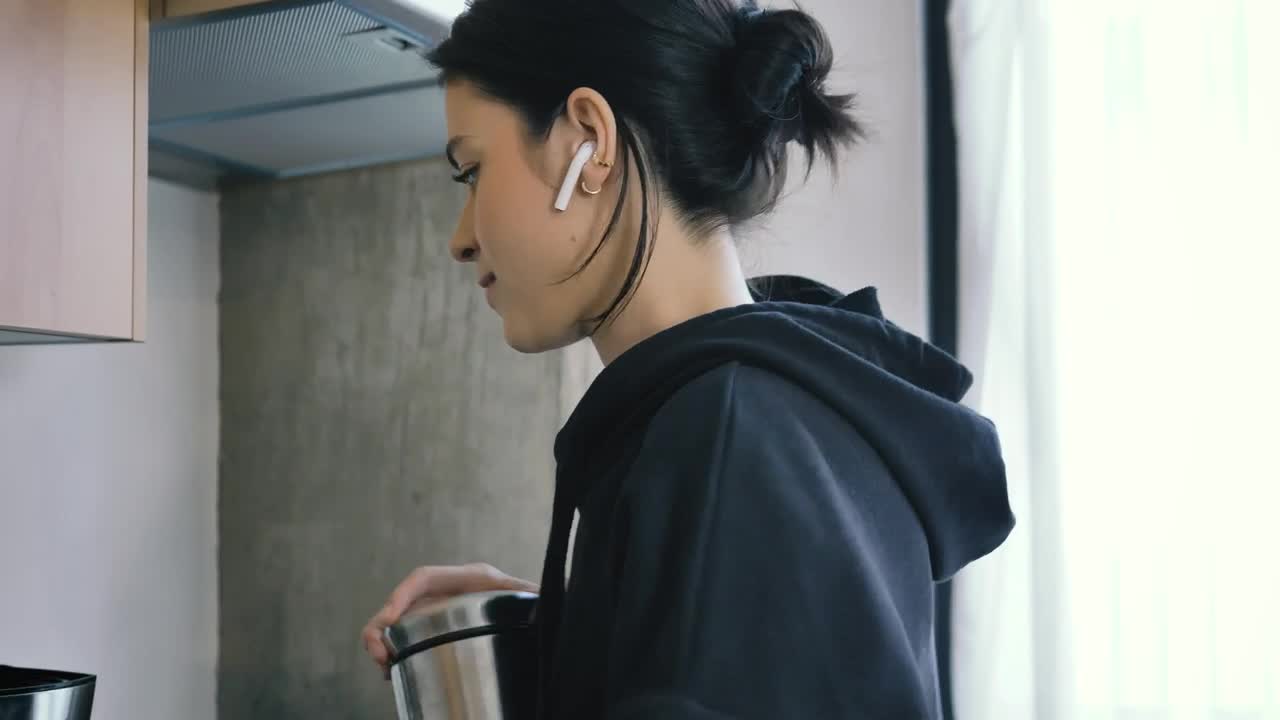 Free Stock Video Woman On Call With Earphones While Preparing Coffee Live Wallpaper