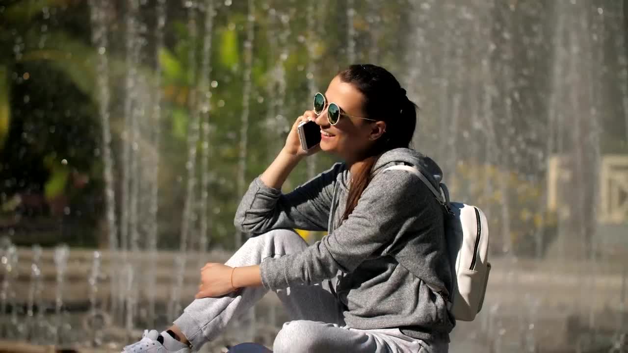 Free Stock Video Woman On A Call Next To The Fountain In A Live Wallpaper