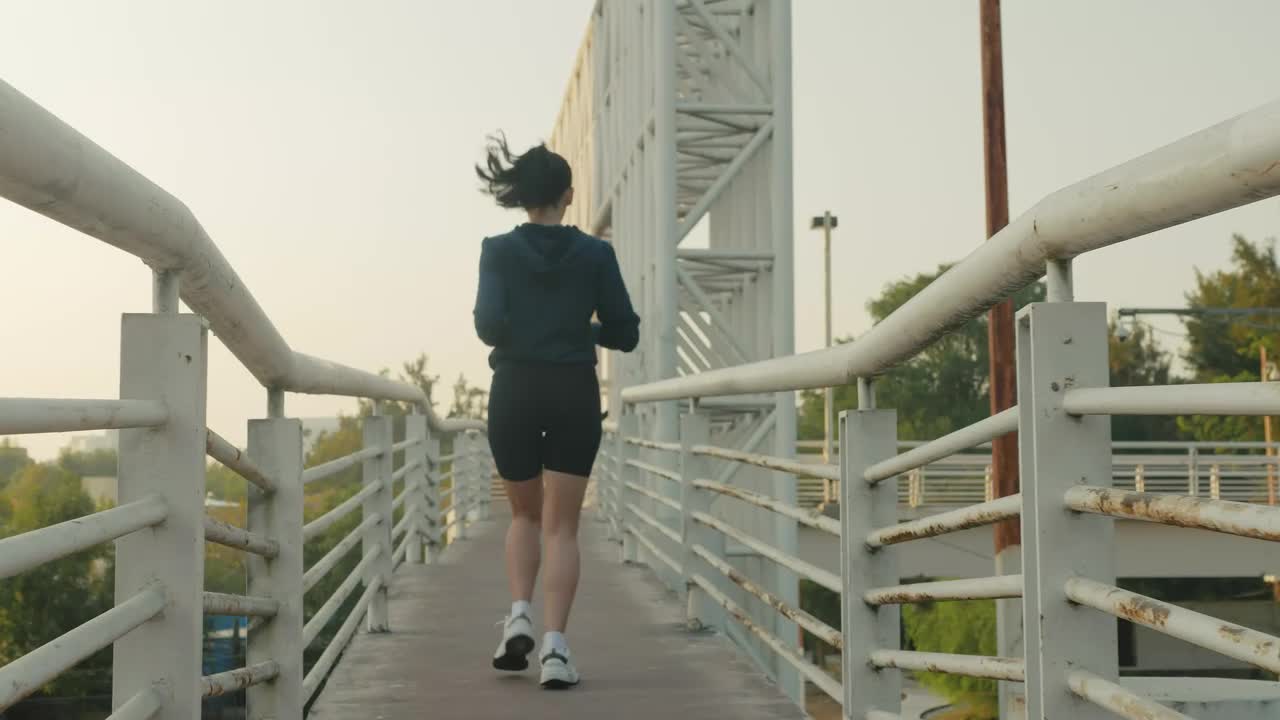Free Stock Video Woman Jogging Across A Narrow Footbridge Live Wallpaper