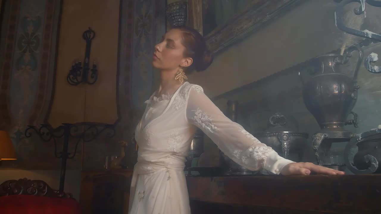 Free Stock Video Woman In A White Dress Models Beside Wodden Furniture Live Wallpaper