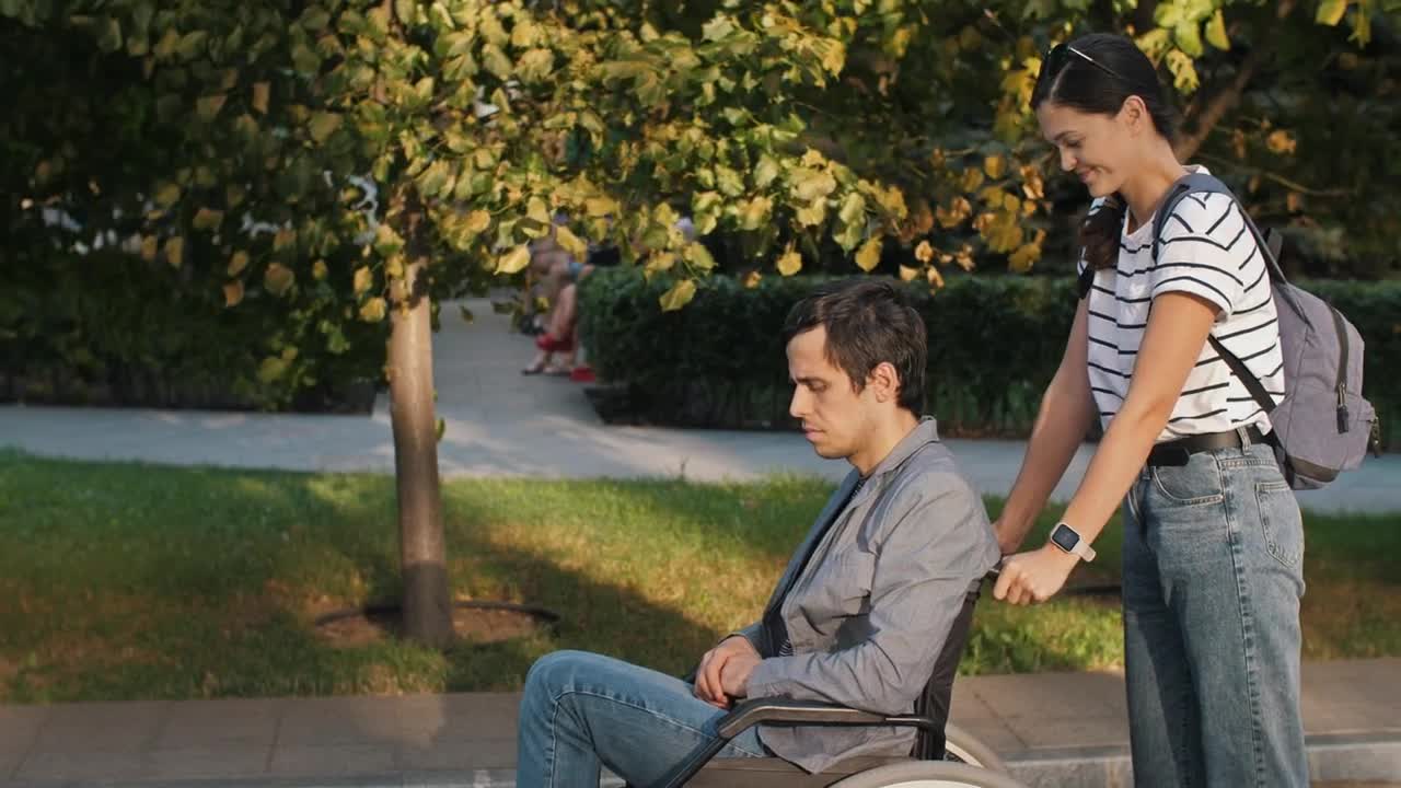 Free Stock Video Woman Helps Man In Wheelchair On The Street Live Wallpaper