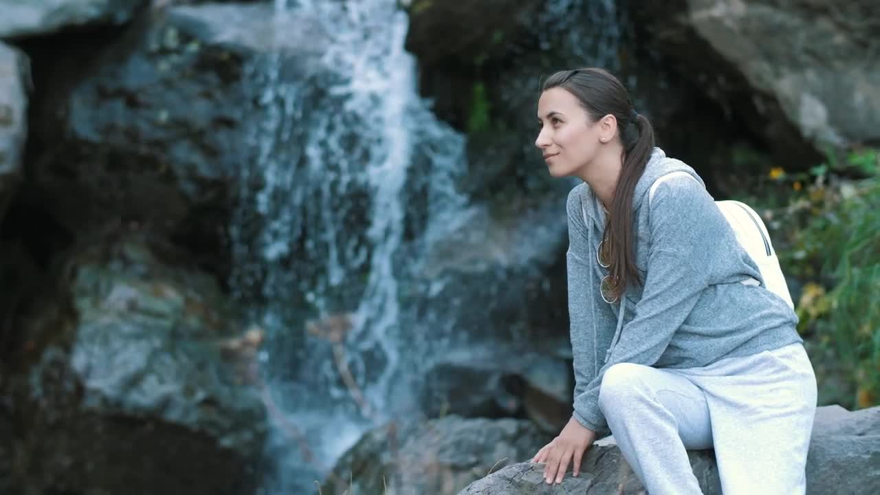 Free Stock Video Woman Enjoying The Shore Of A Waterfall Live Wallpaper