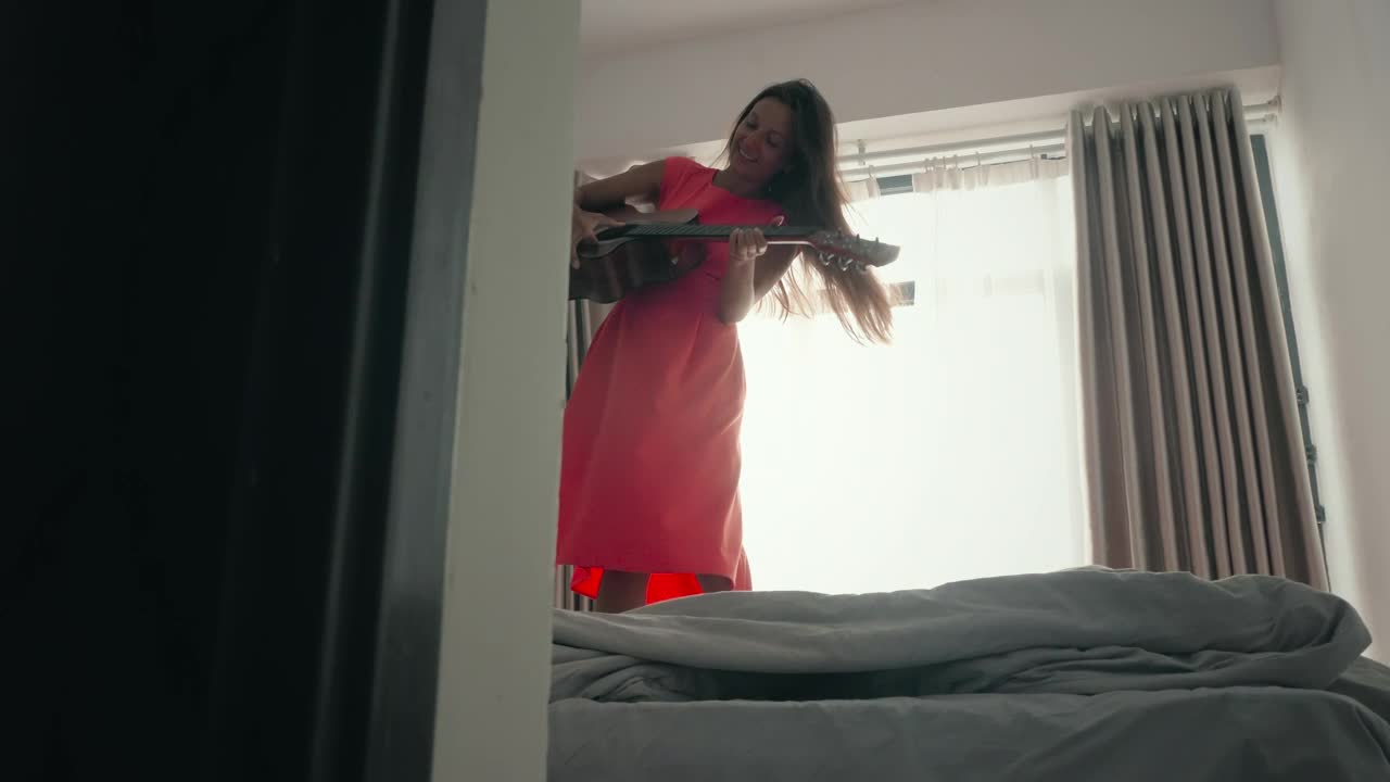 Free Stock Video Woman Dancing On The Bed And Playing The Guitar Live Wallpaper