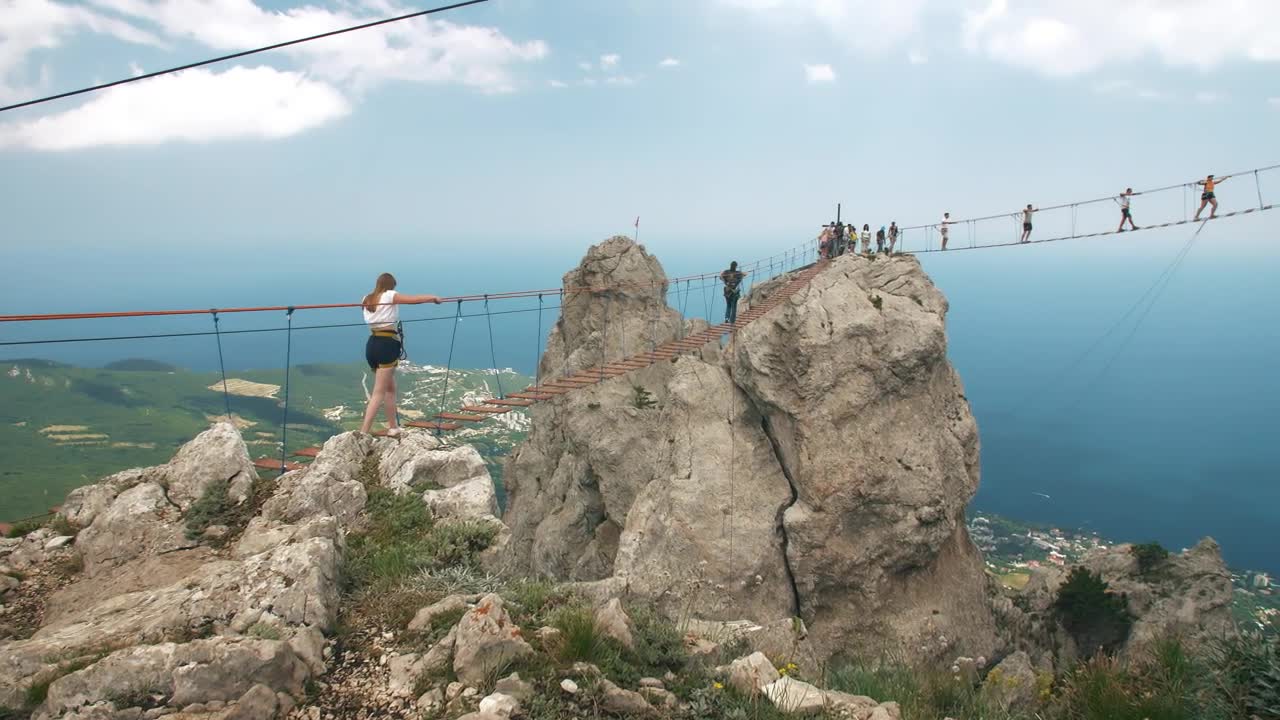 Free Stock Video Woman Crossing A Suspension Bridge In The Mountains Live Wallpaper
