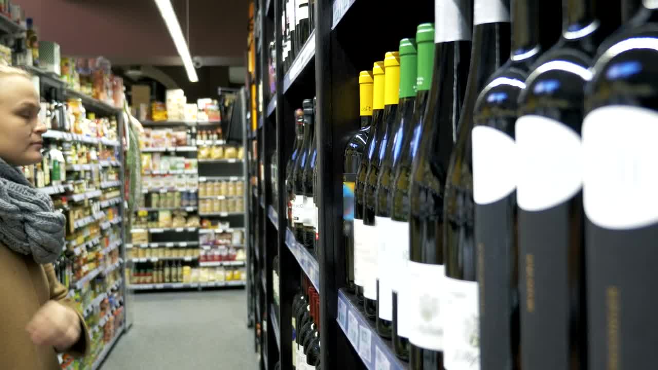   Stock Footage Woman Choosing A Bottle Of Wine Live Wallpaper