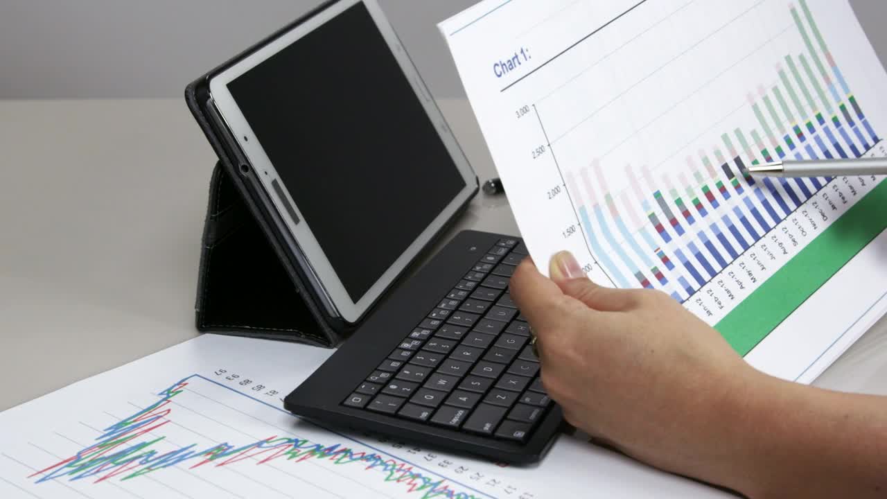   Stock Footage Woman Checking A Graph At Work Live Wallpaper