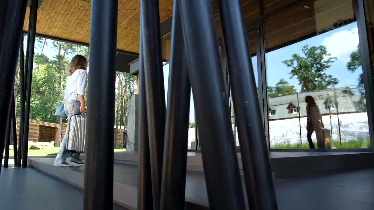   Stock Footage Woman Carrying A Suitcase Arriving At A Hotel Live Wallpaper